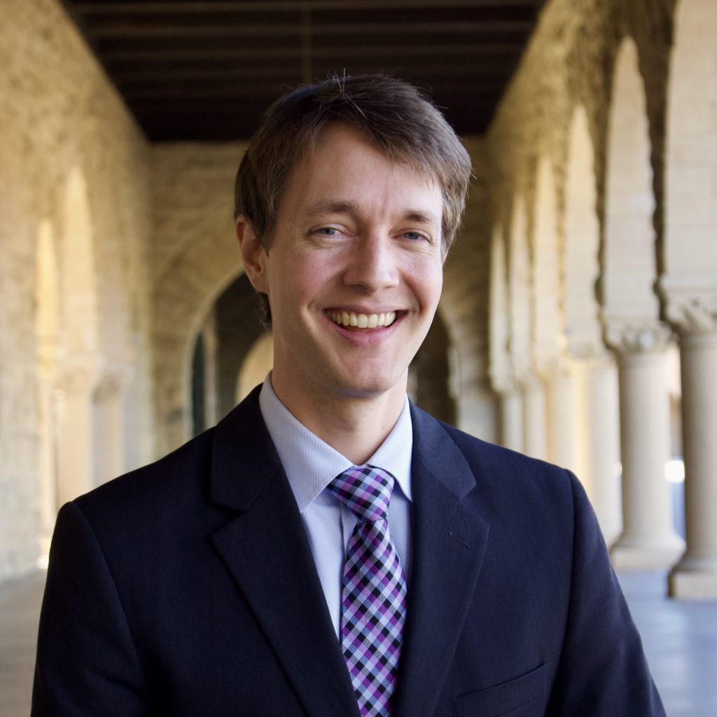 Economist Trevor Bakker smiles in the Main Quad of Stanford University.